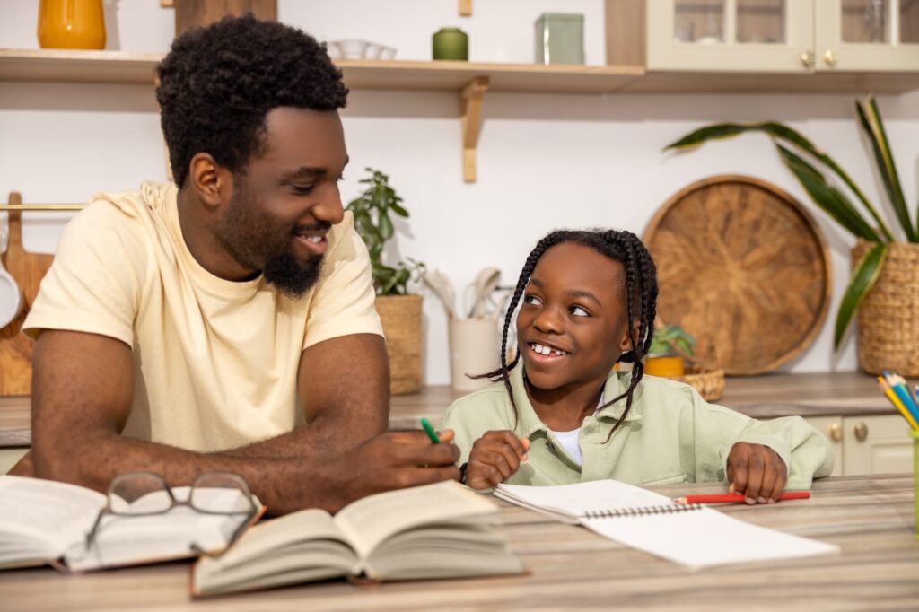 African American female student smiling and looking at father