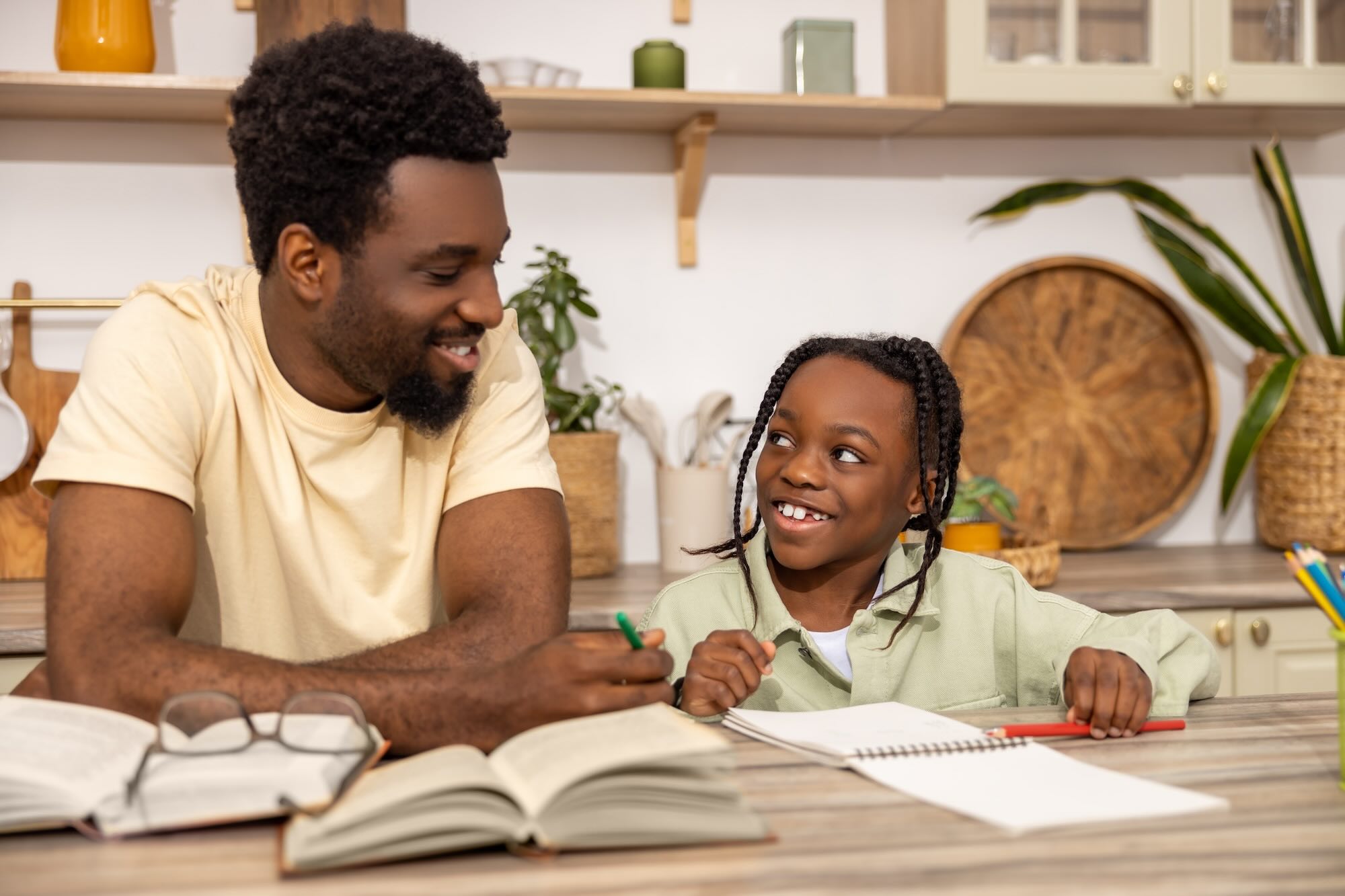 African American female student smiling and looking at father