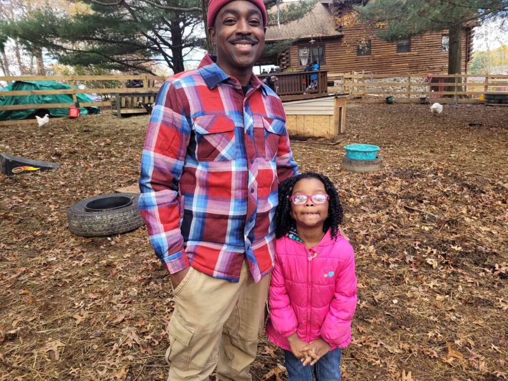 Father and daughter outside wearing warm clothes for field trip