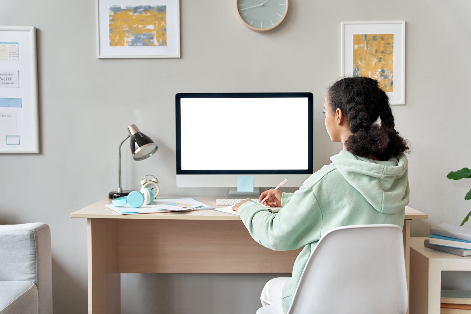 woman looking at computer at home learning space