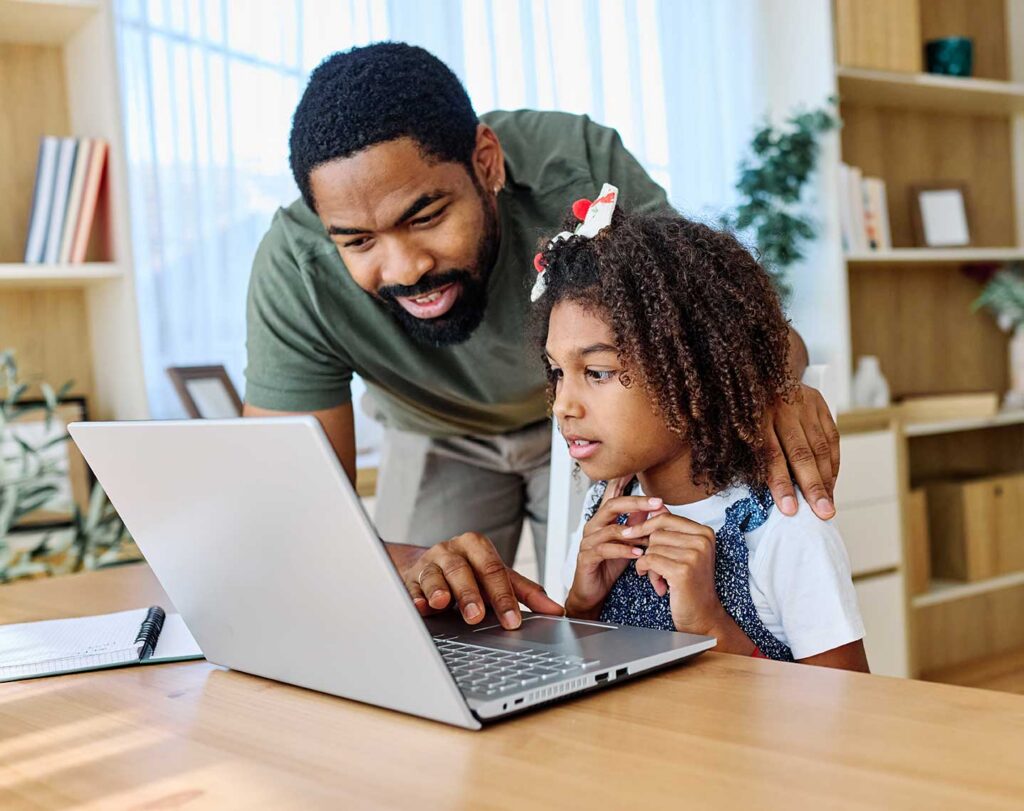 dad and daughter on a computer together